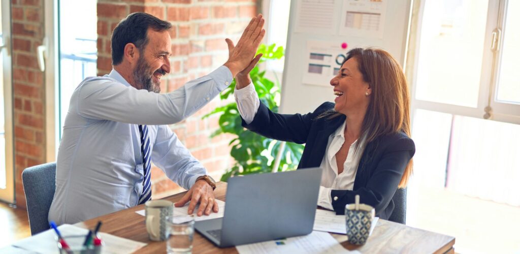 Happy business owner consulting with an AI Risk specialist